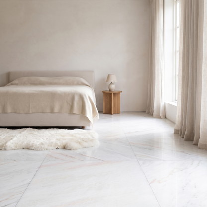 Bianco Rosa marble floor in a light-filled bedroom