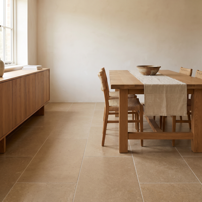 Mocha limestone floor in a warm bright dining room