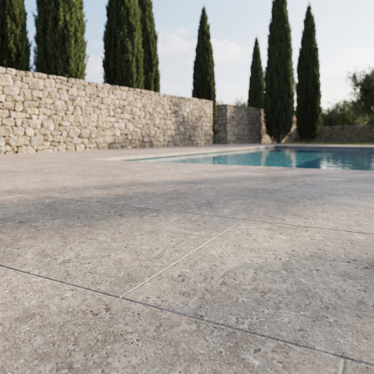 Pewter Travertine porcelain paving in an outdoor setting