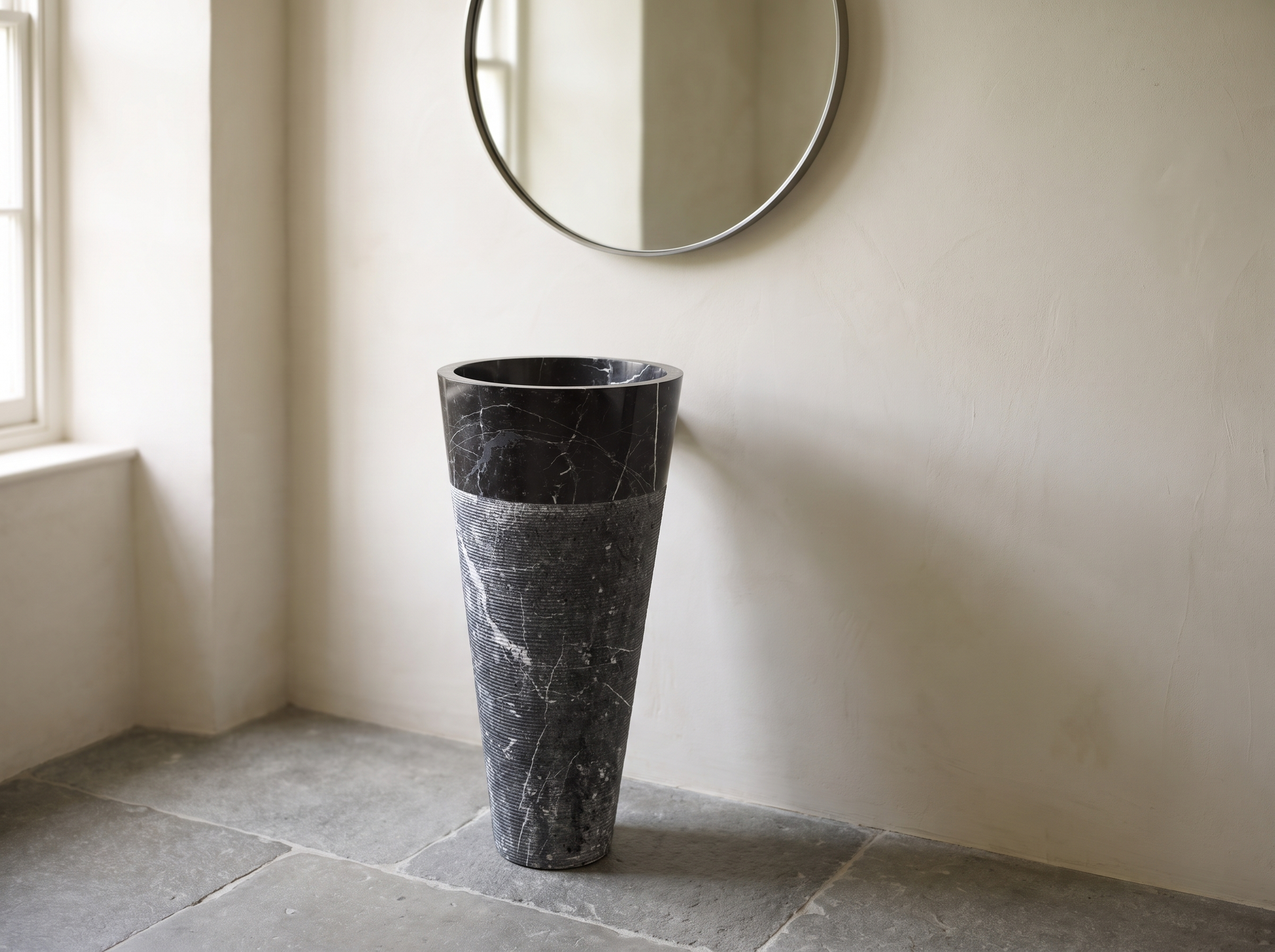 Torre natural stone freestanding pedestal basin in a bathroom setting