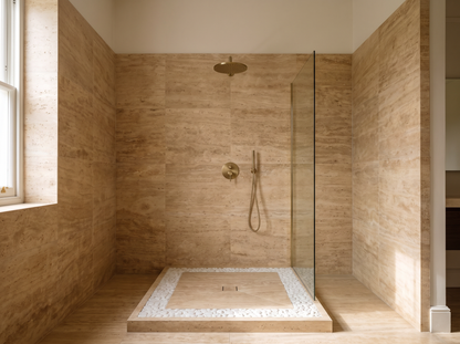 Levanto travertine shower tray in a walk-in shower